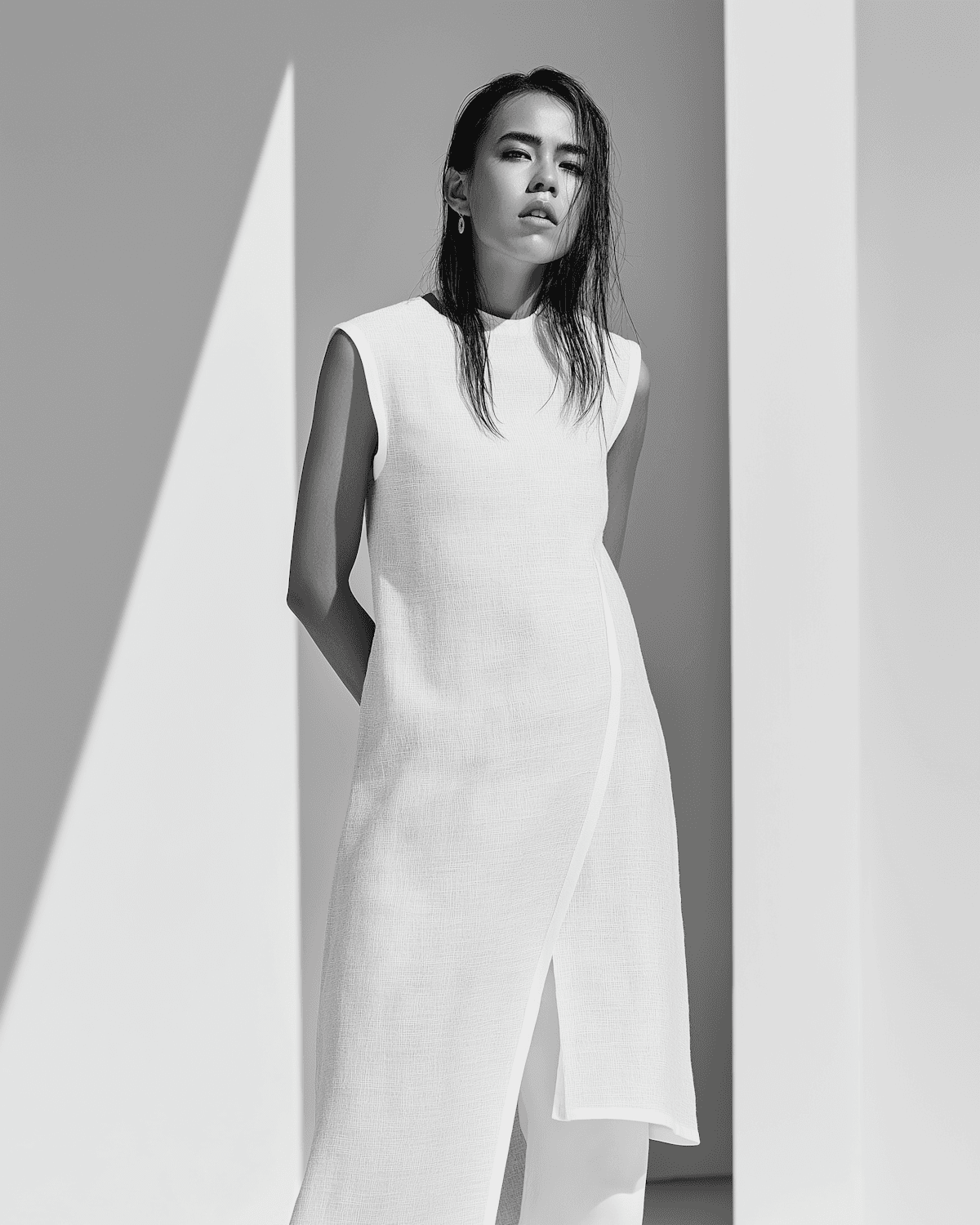 Black and white portrait cut by architectural shadows